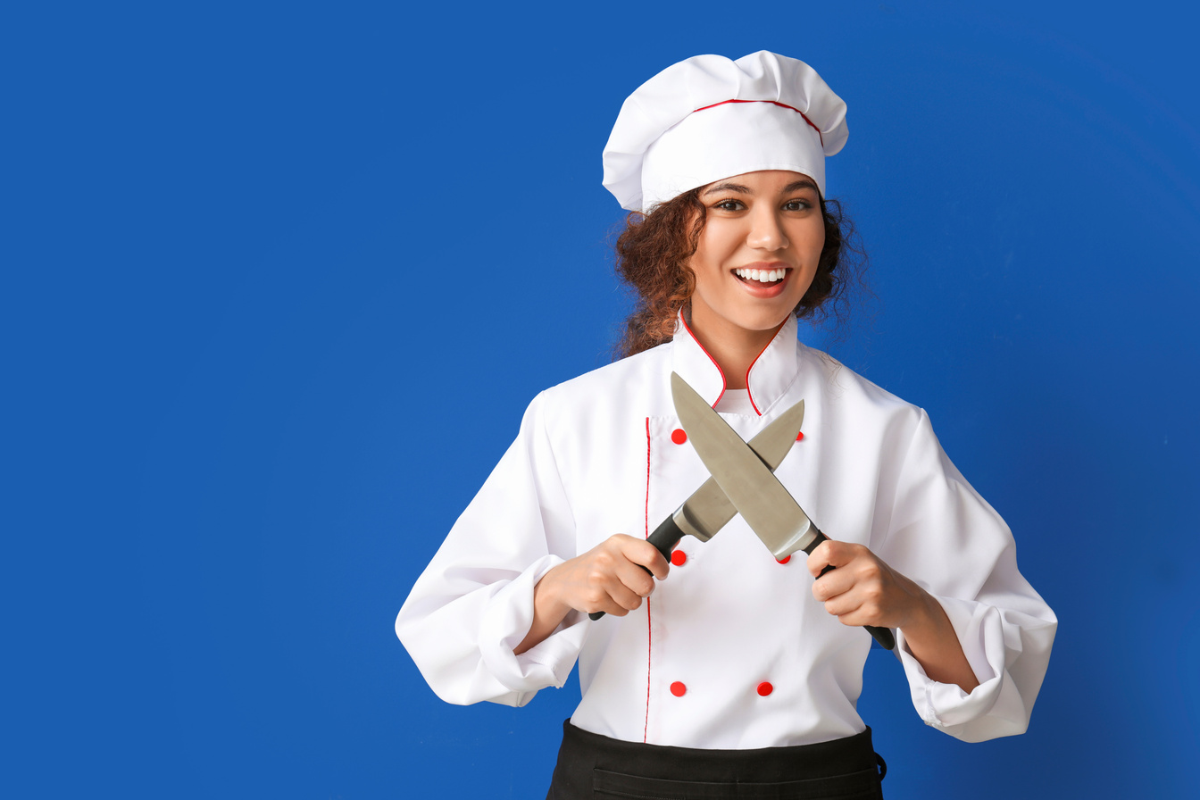 Female Chef with Knives on Blue Background